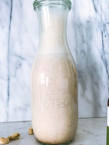 Vanilla cashew milk in a weck jar with cinnamon and cashews.