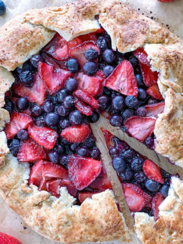Mixed Berry Galette with sourdough crust with one slice cut out.