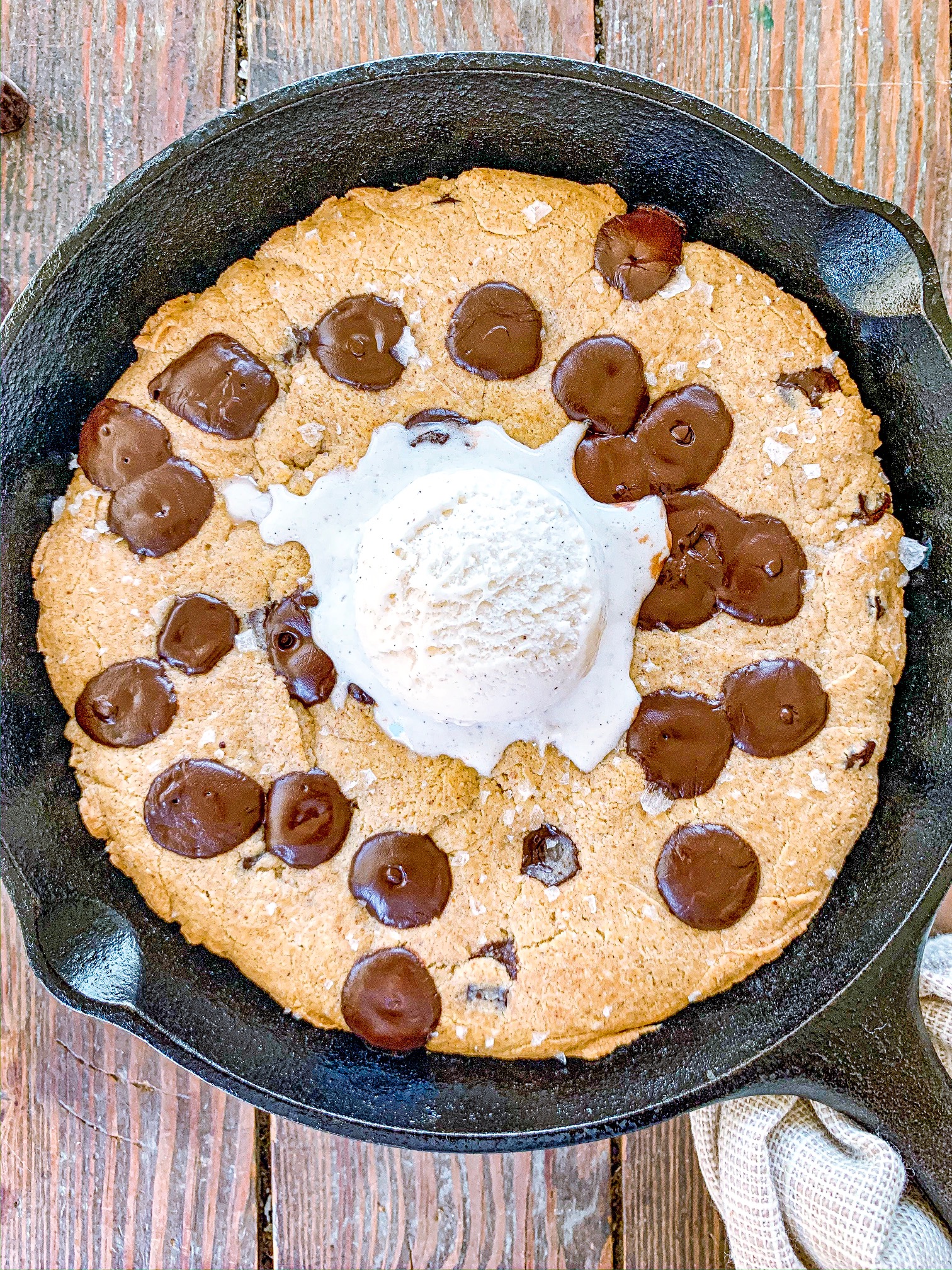 Gluten-Free Chocolate Chip Skillet Cookie with a scoop of vanilla ice cream on top.
