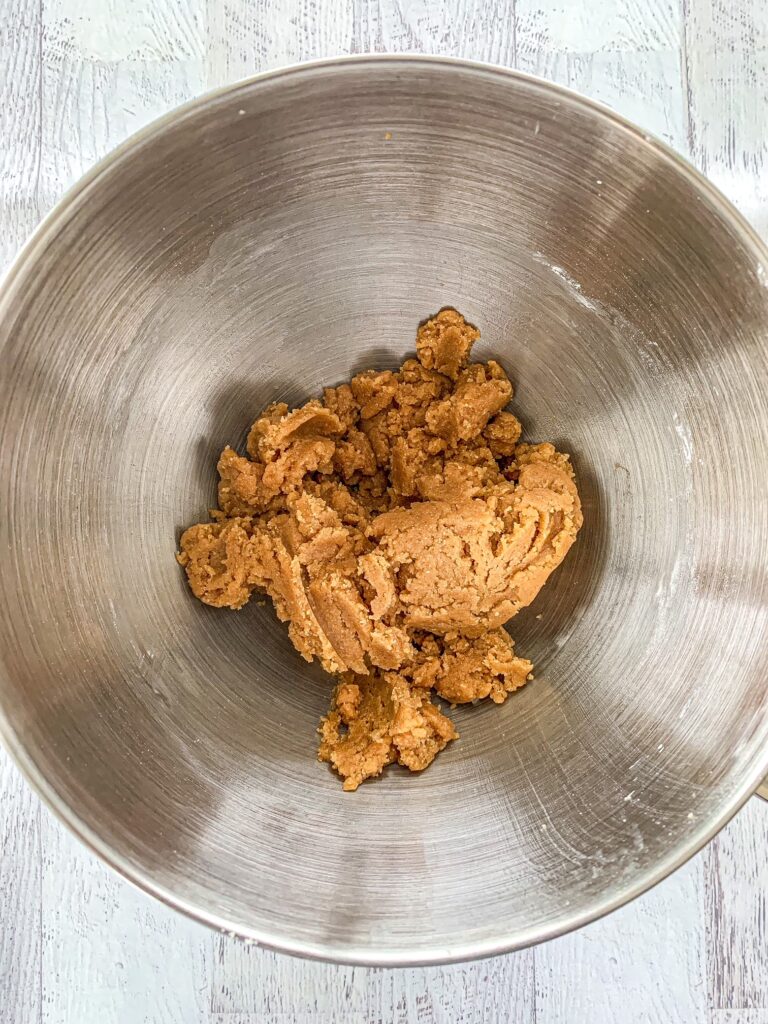 Gluten-Free, Dairy-Free cookie dough in the base of a silver stand mixer bowl.