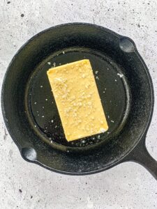 Stick of butter in a cast iron skillet sprinkled with Sea Salt.