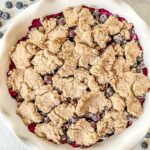 Vegan Blueberry Cobbler in a white pie dish.
