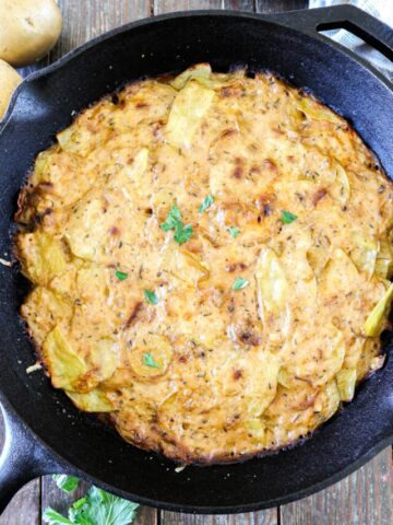 Traeger Scalloped Potatoes in a cast iron skillet.