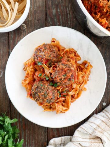 Gluten-Free Meatballs on a white plate with spaghetti.