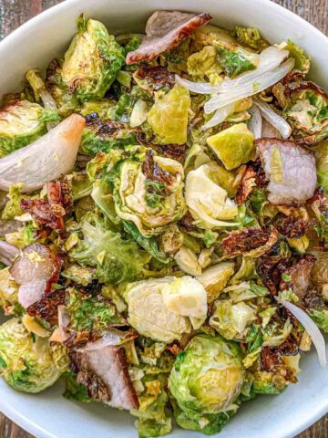 Overhead shot of Maple bacon brussels sprouts in a white bowl.