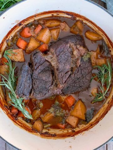 Dutch Oven Pot Roast with a sprig of rosemary.