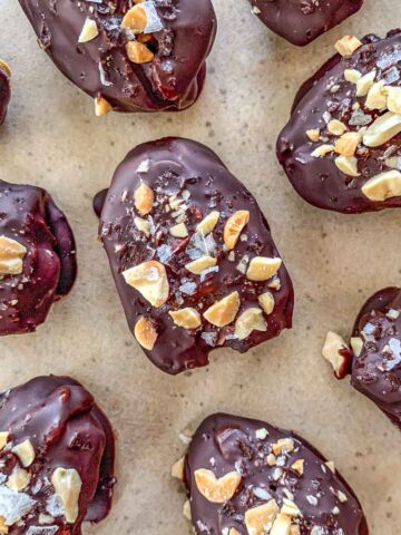 Snickers Stuffed Dates on parchment paper.