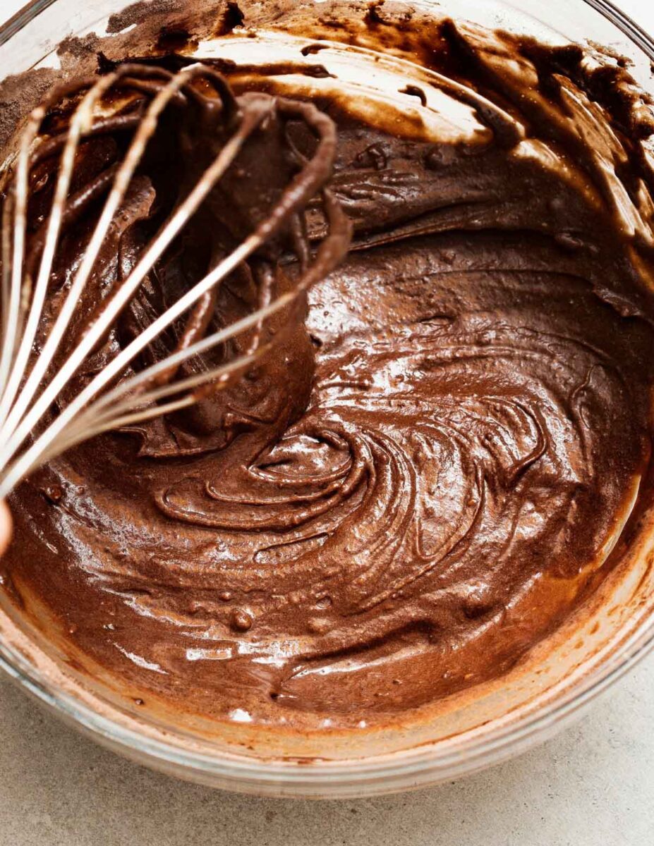 Sourdough brownie batter in a bowl with a whisk.