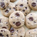 Sourdough discard chocolate chip cookies on parchment paper.