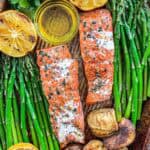 Traeger Grilled Salmon on a sheet pan with asparagus, roasted potatoes and lemon.