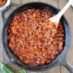 Traeger Baked beans in a cast iron skillet.