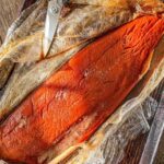 Traeger smoked salmon on plastic wrap.