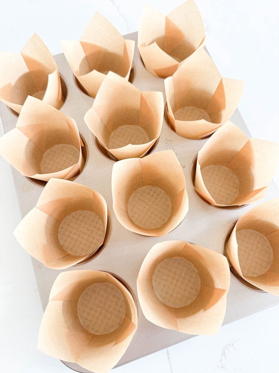 Parchment muffin liners in a muffin tin.