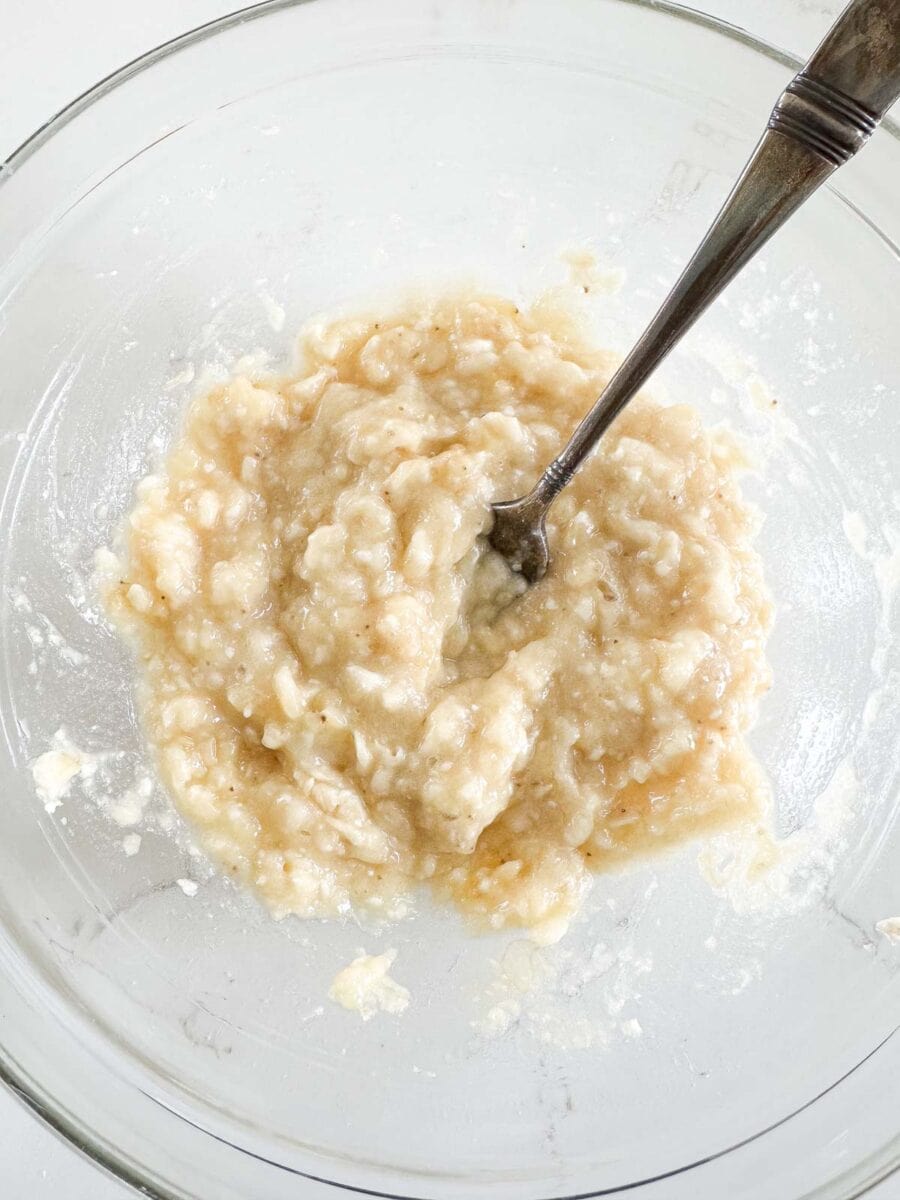 Mashed bananas in a glass bowl.