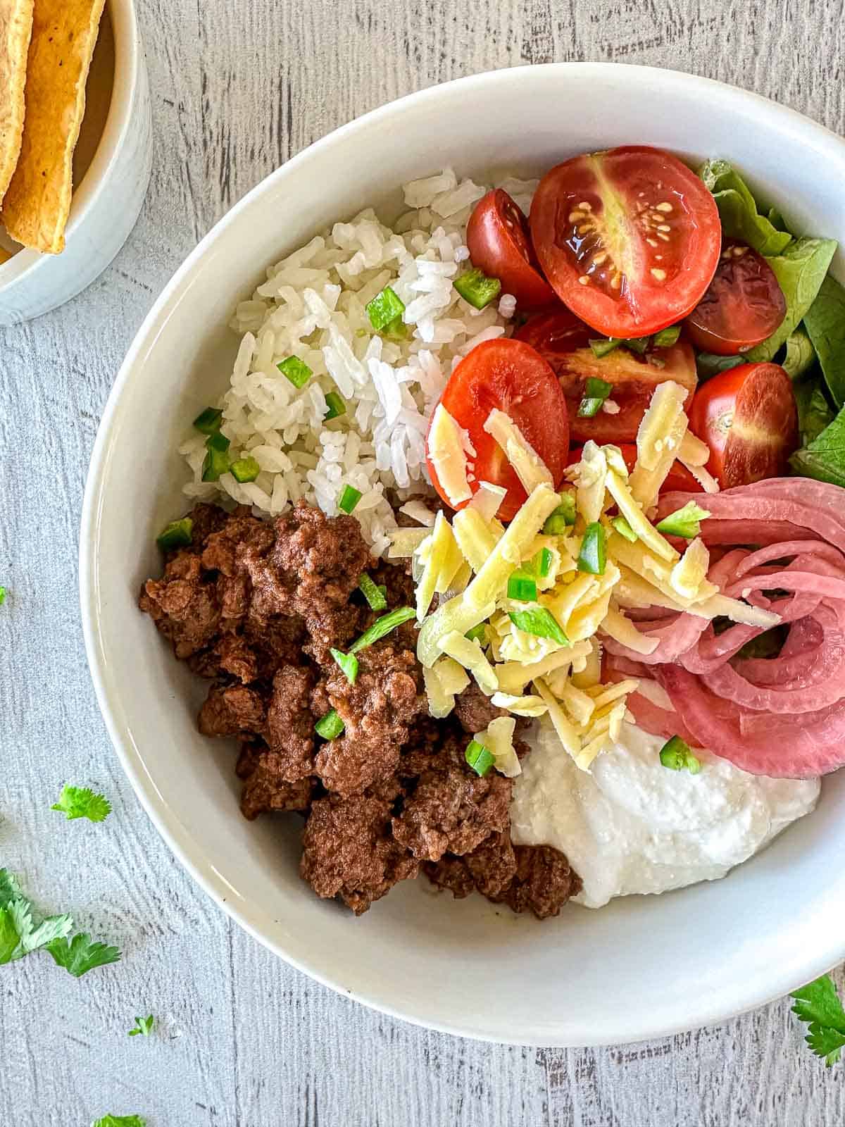 A cottage cheese taco bowl with a side of corn chips.
