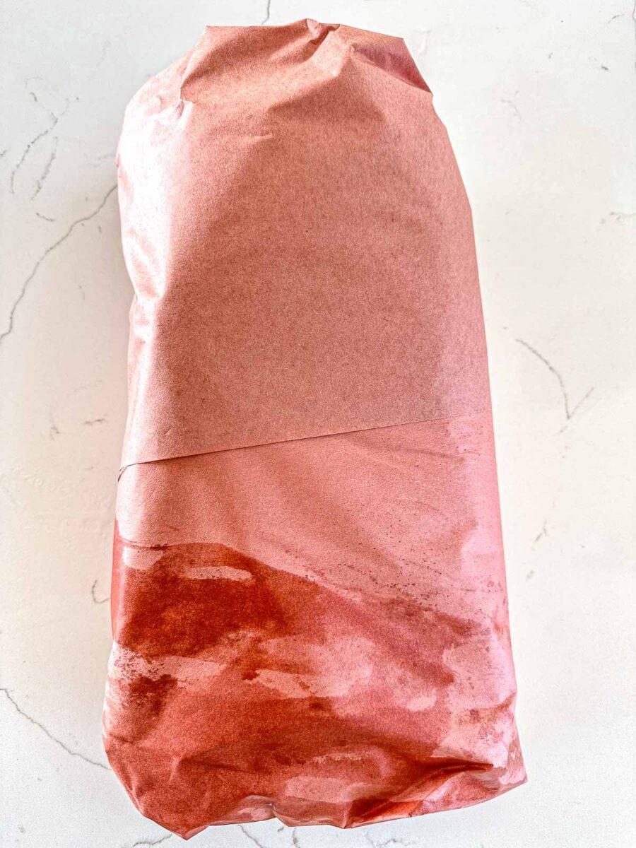 Smoked brisket wrapped in butcher paper.