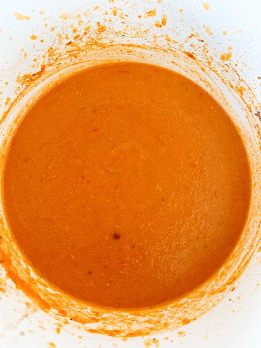 Blended roasted butternut squash and tomatoes in a Dutch oven.