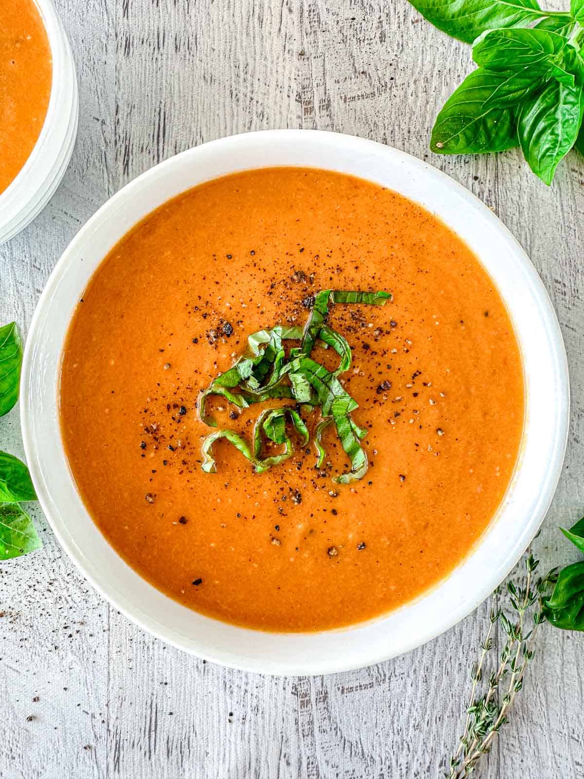 Butternut Squash And tomato Soup in a white bowl.