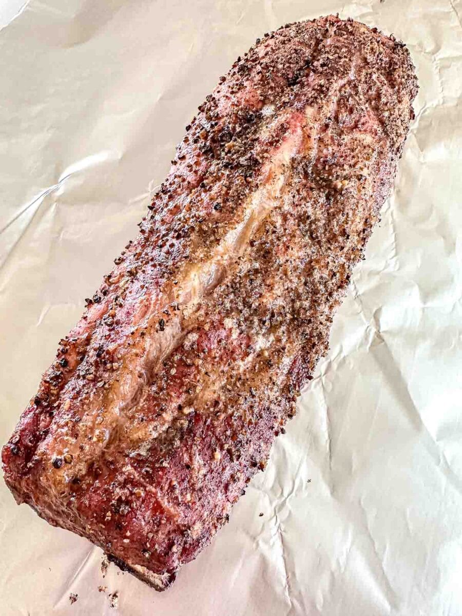 Baby back ribs sitting on aluminum foil.