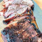 Smoked ribs on a cutting board.