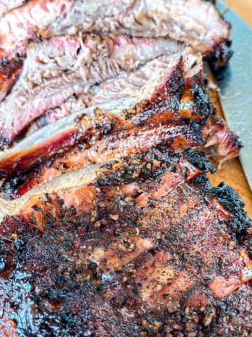Smoked ribs on a cutting board.