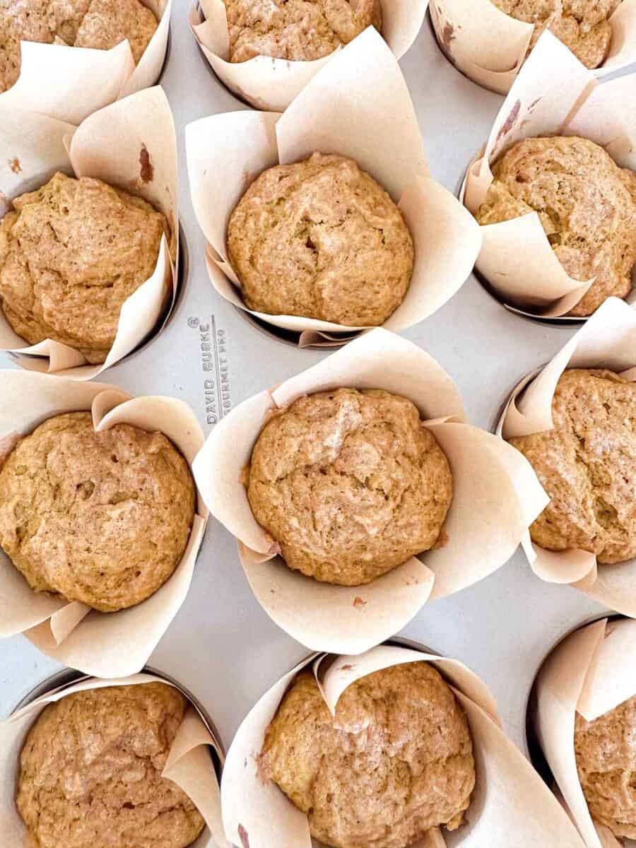 A tray of sourdough pumpkin muffins with a coconut sugar topping.