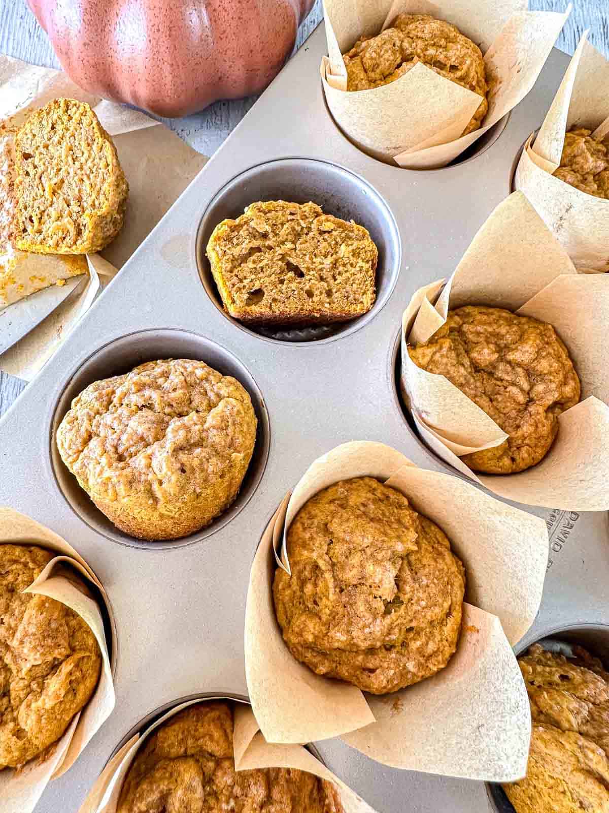 Sourdough pumpkin spice muffins in a muffin tin.