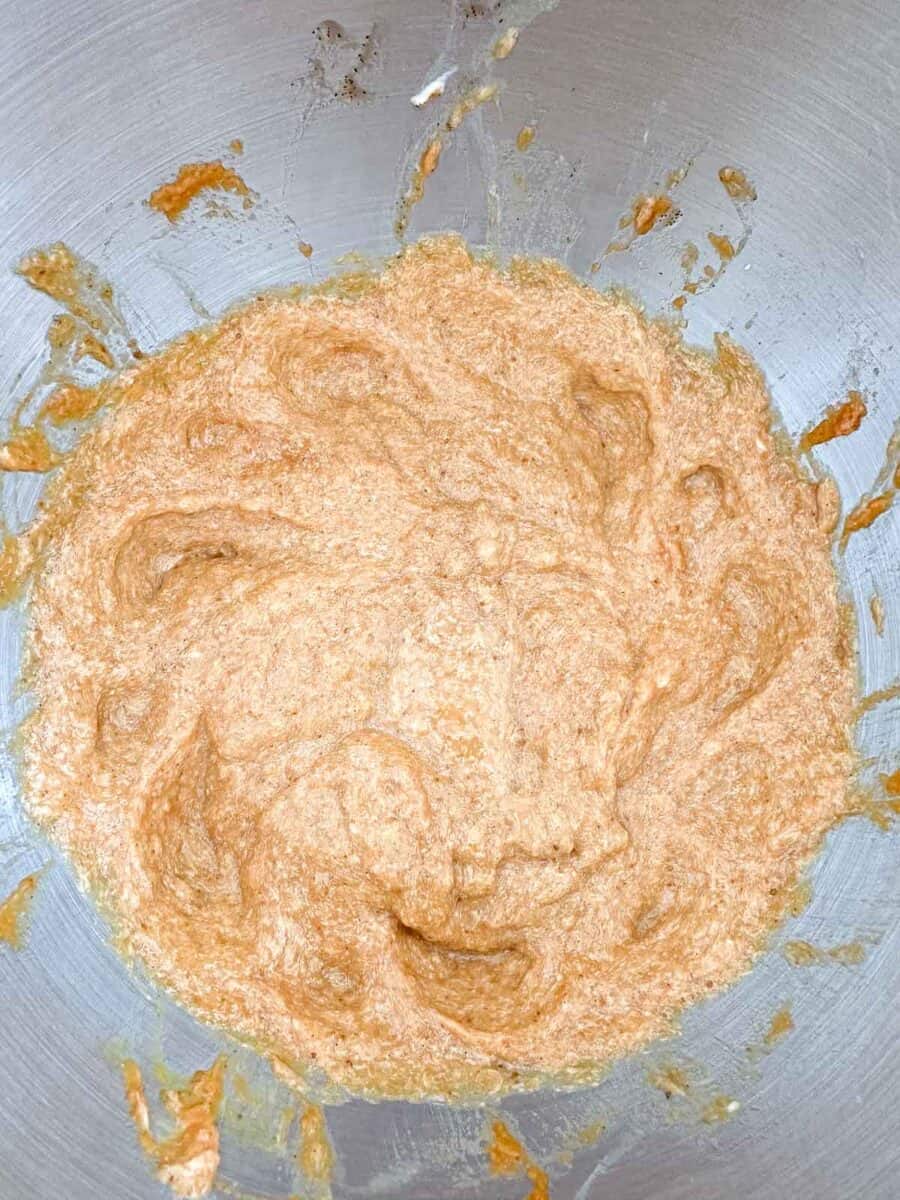 A bowl of batter in a stand mixing bowl.