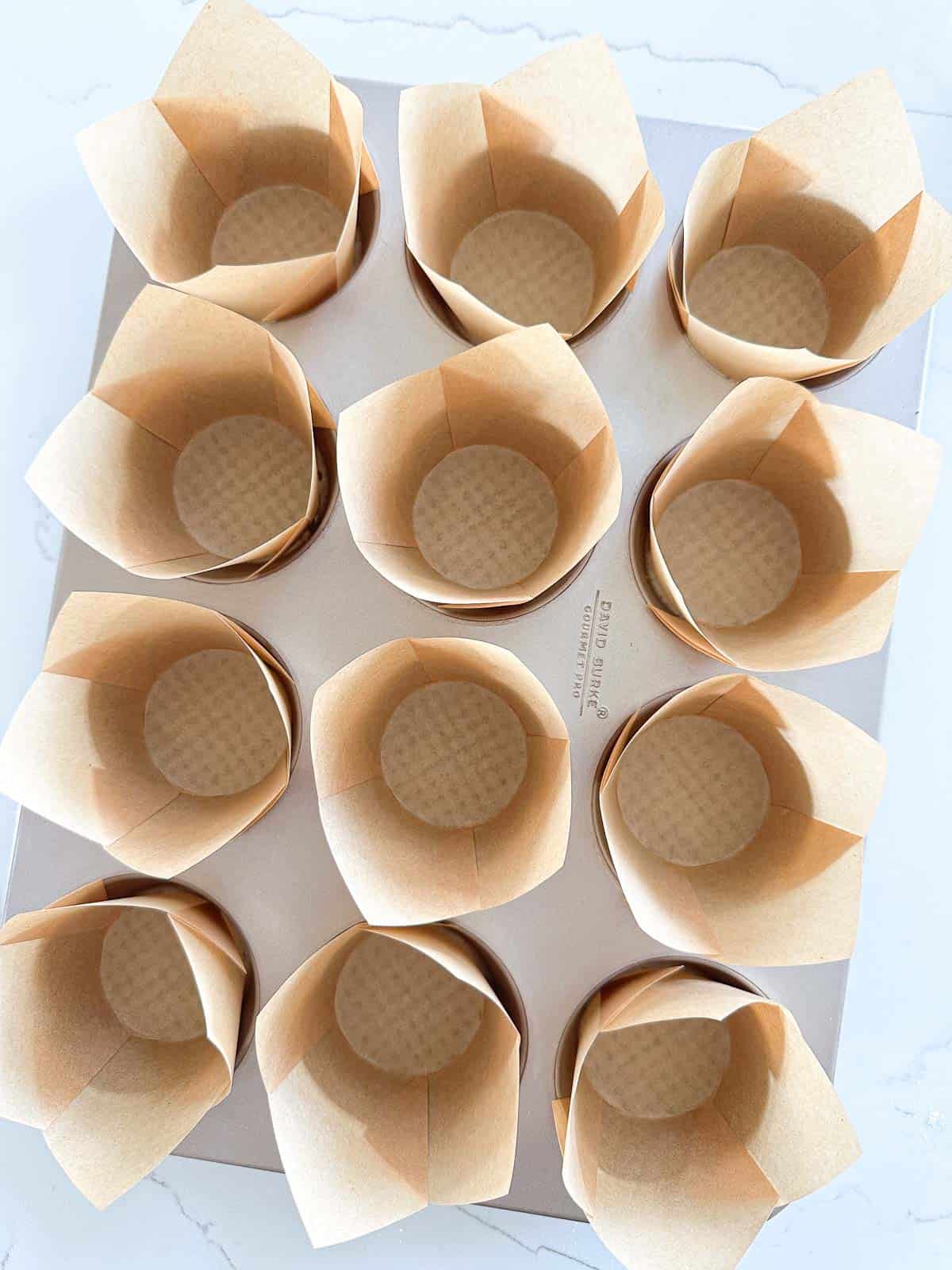 A muffin pan filled with paper cups.
