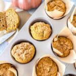 Pumpkin sourdough muffins in a muffin tin.